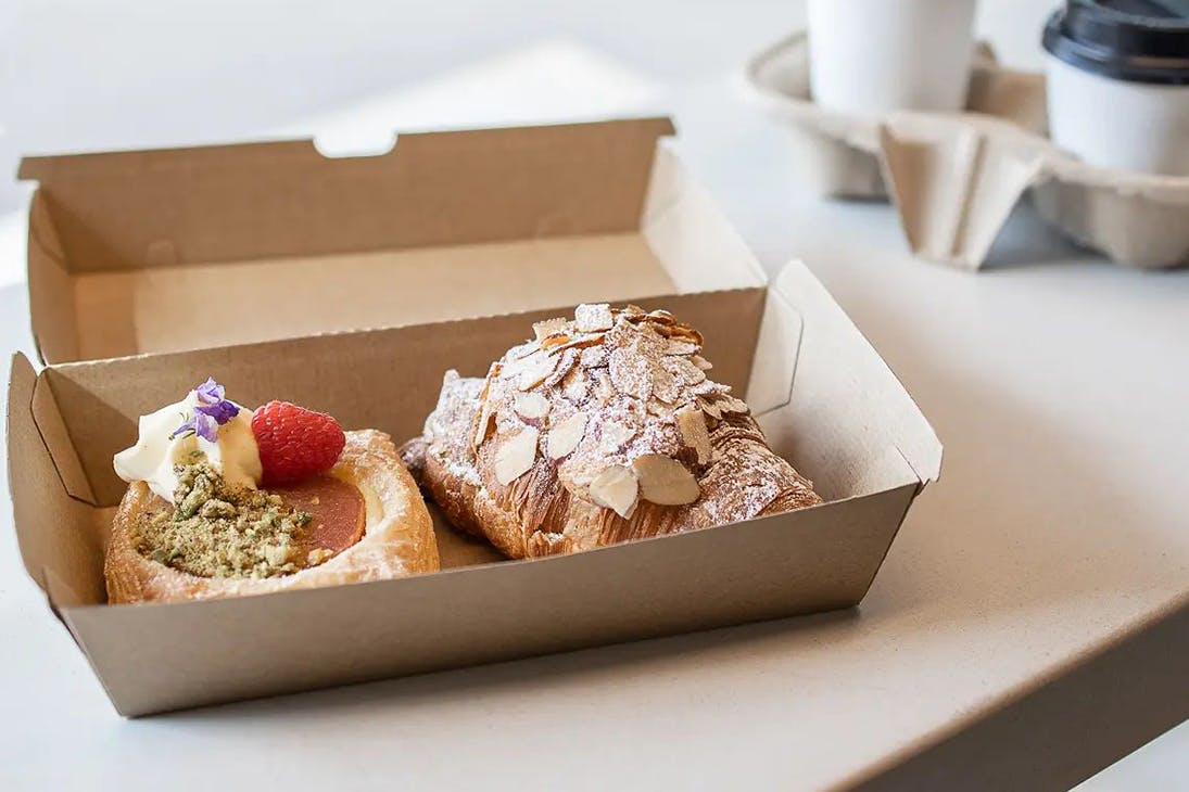 two pastries in a takeaway box
